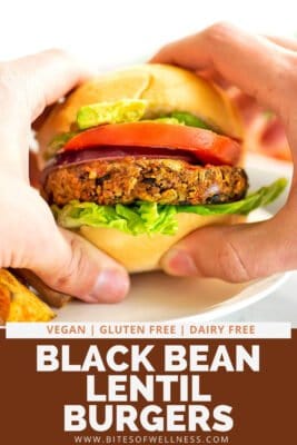 Hands holding a black bean lentil burger.