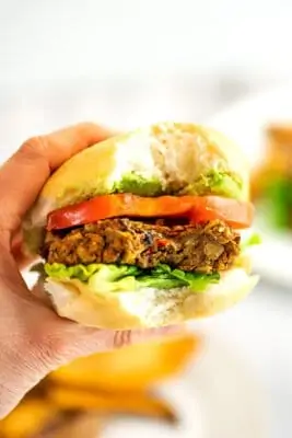 Bite taken out of a lentil black bean burger.