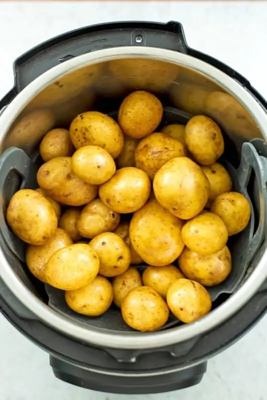 Baby potatoes in a steam basket in the instant pot.