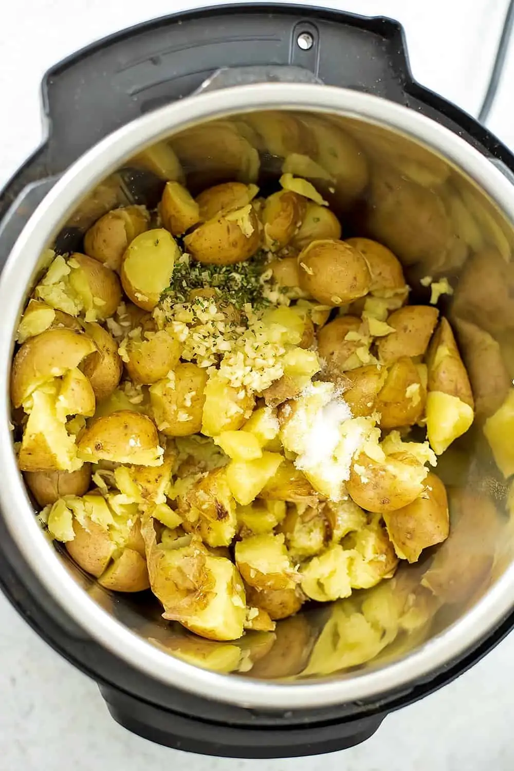 Cut potatoes in the instant pot with seasoning on top.