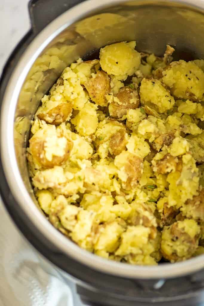 Instant pot filled with rosemary garlic potatoes.