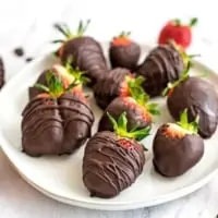 Plate full of chocolate covered strawberries.