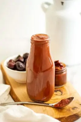 Glass bottle filled with chipotle cherry bbq sauce.