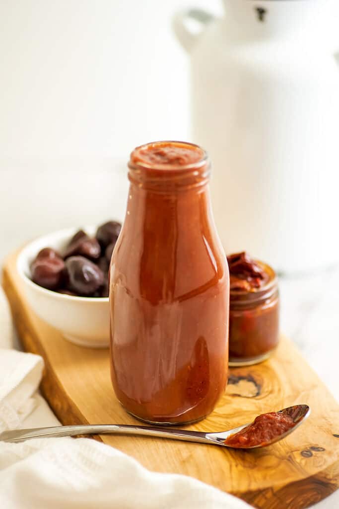 Glass bottle filled with chipotle cherry bbq sauce.