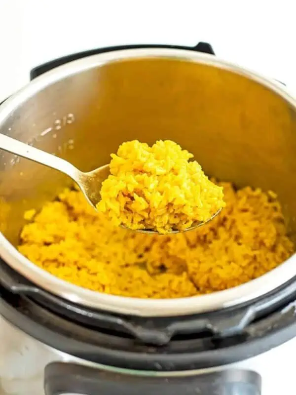 Spoonful of yellow rice out of the instant pot.