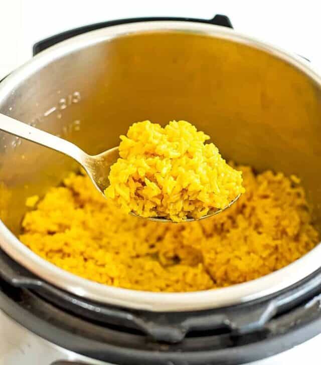 Spoonful of yellow rice out of the instant pot.