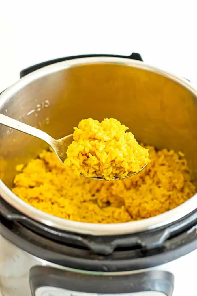 Spoonful of yellow rice out of the instant pot.