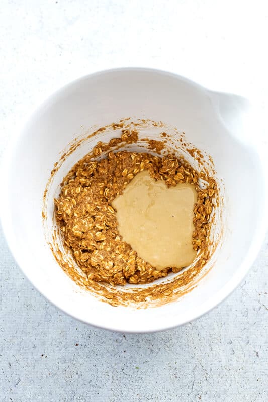 Tahini added to bowl with rolled oats.