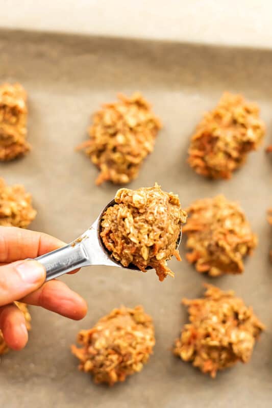Measuring spoon full of carrot cake cookie dough.