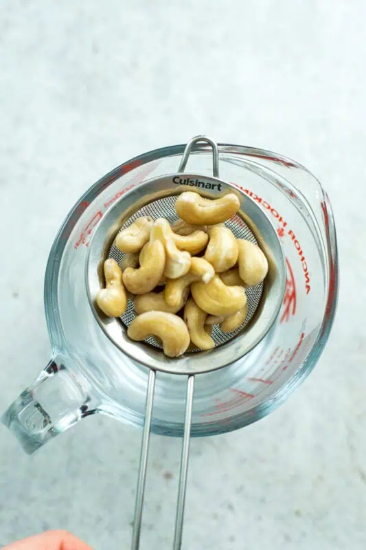Cashews in a mesh strainer.