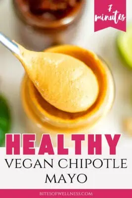 Spoonful of vegan chipotle mayo being lifted from a glass jar.