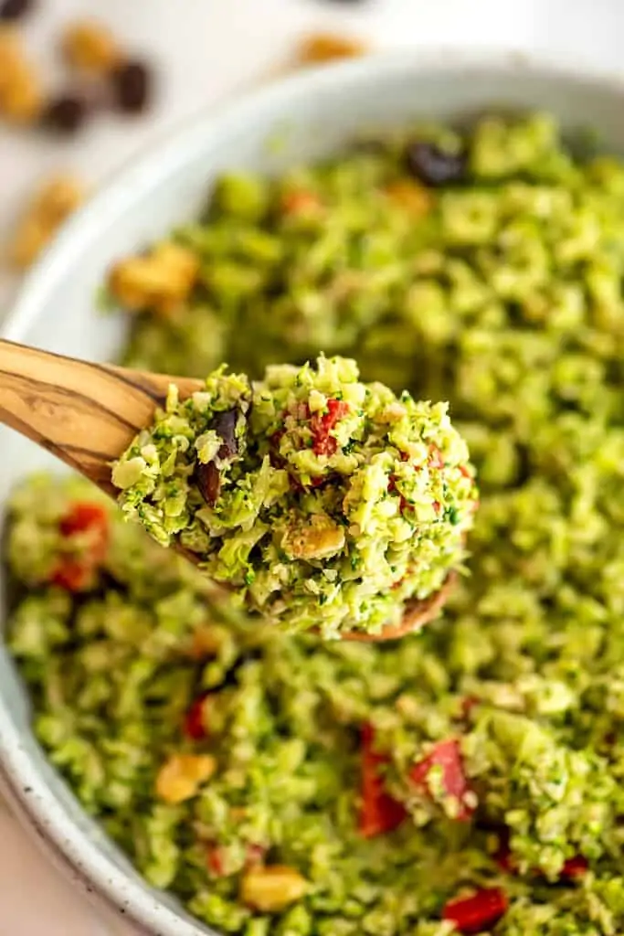 Large spoonful of riced broccoli salad.