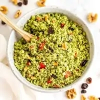 Riced broccoli salad with walnuts and cranberries in bowl.