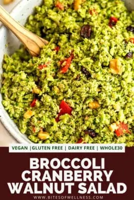 Large bowl filled with riced broccoli salad with cranberries.
