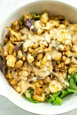 Roasted cauliflower, onions and beans over salad greens with lemon tahini dressing.