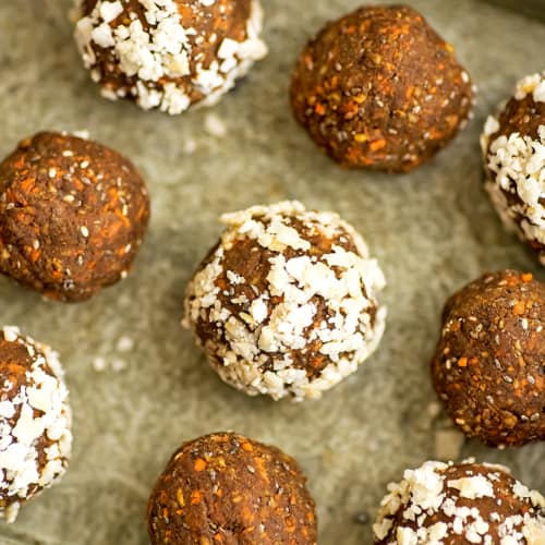 Carrot cake energy bites on a green tray.