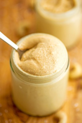 Spoon in a jar of cashew coconut butter.