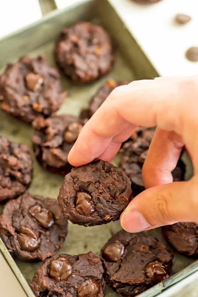 Hand grabbing for a protein brownie bite.