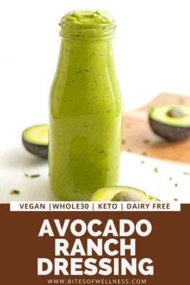 Bottle of vegan avocado dressing with avocados in background..