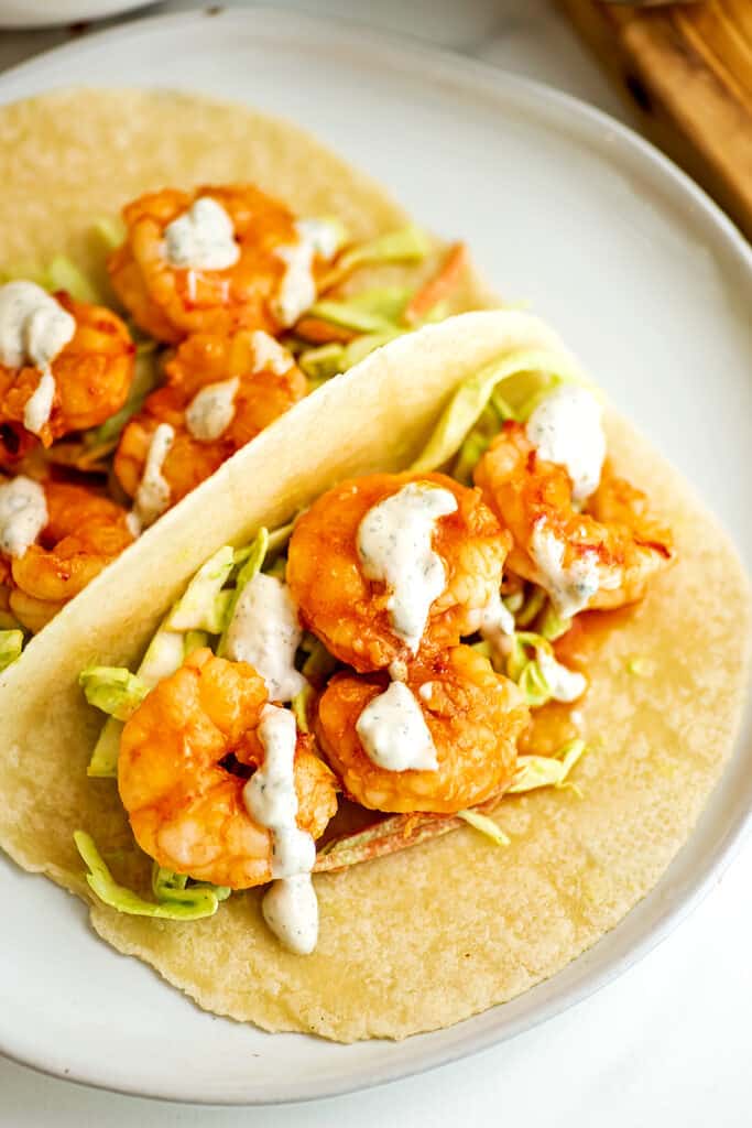 Buffalo grilled shrimp taco with slaw and ranch dressing.