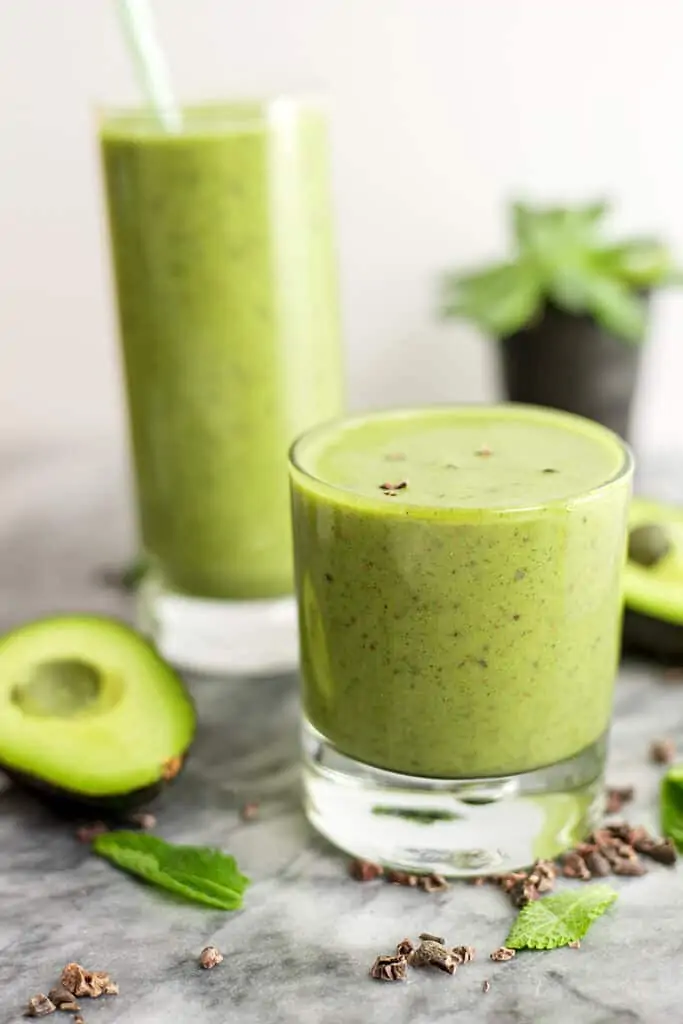 Mint avocado protein shake in a short glass.