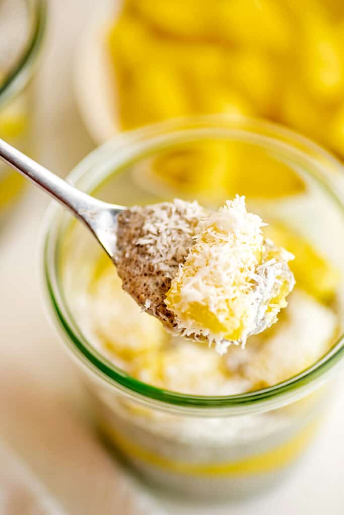 Spoonful of chia pudding with a piece of pineapple.