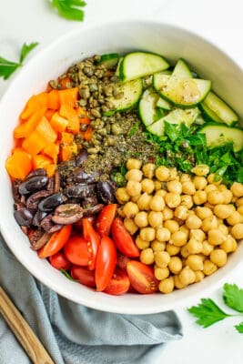 Chopped Mediterranean Salad in a white bowl over blue napkin.