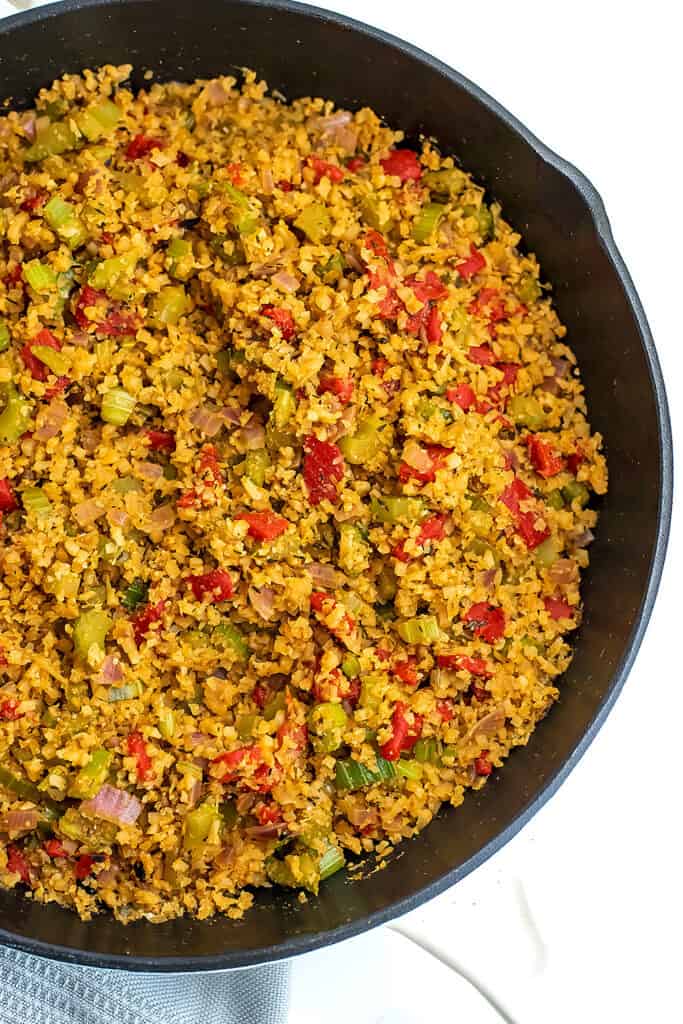 Cauliflower dirty rice in a cast iron skillet.