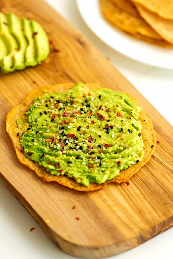 Lentil flatbread with mashed avocado on top.
