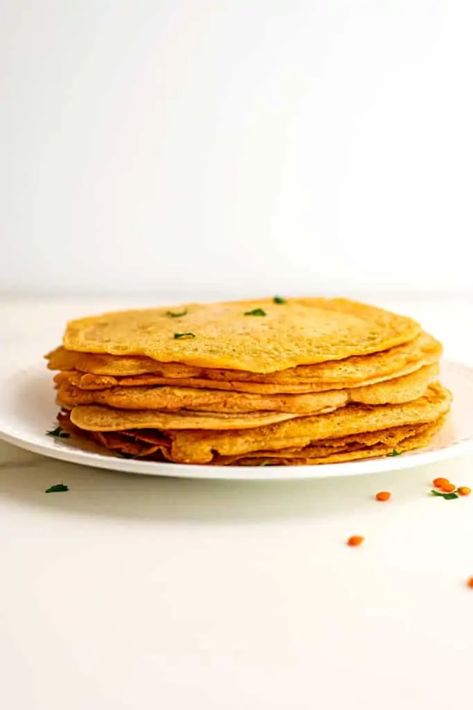 Lentil flatbreads stacked on top of eachother.