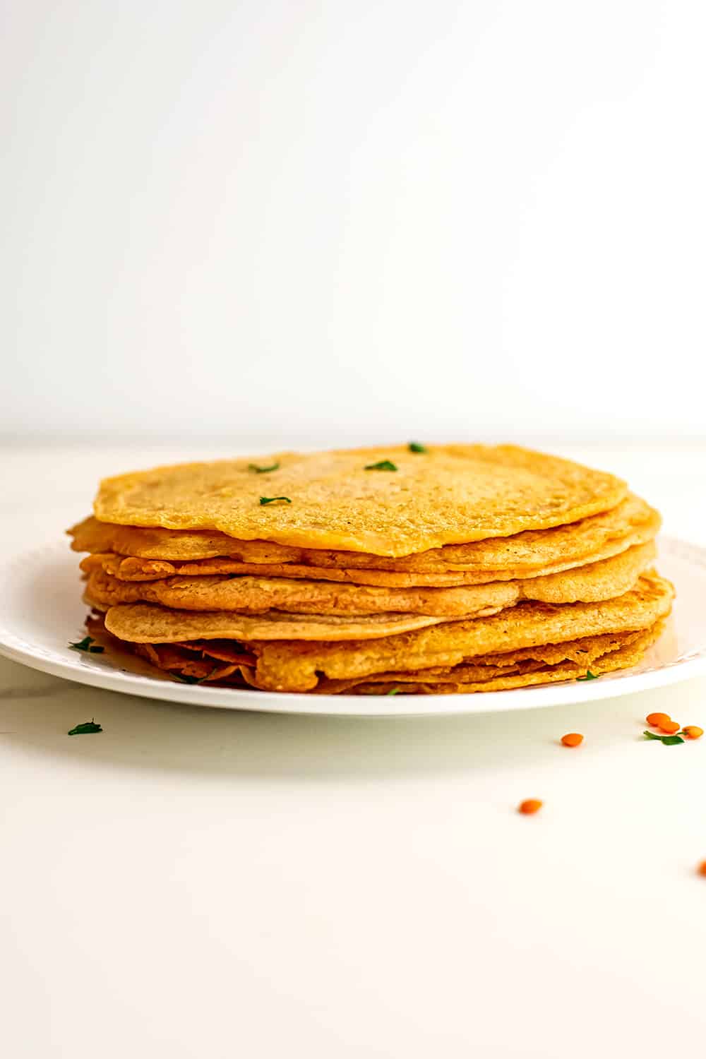 Lentil flatbreads stacked on top of eachother.