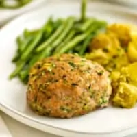 Ranch turkey meatloaf on a white plate with green beans.