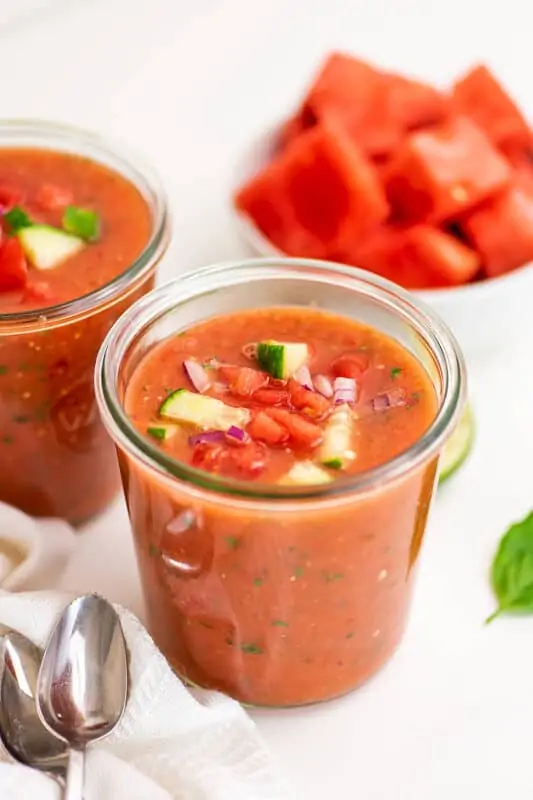 Glass jar filled with watermelon gazpacho.