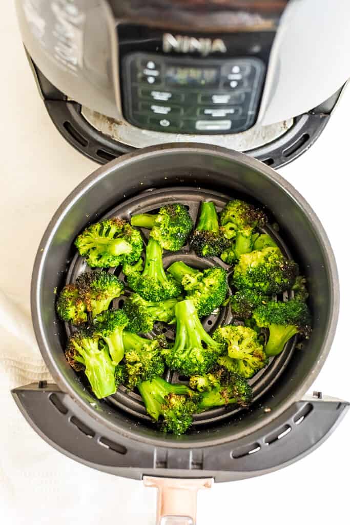 Broccoli in the air fryer after being cooked from frozen.