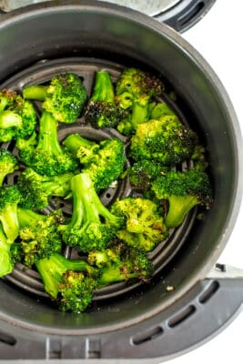 Air fryer frozen broccoli in air fryer after cooking.