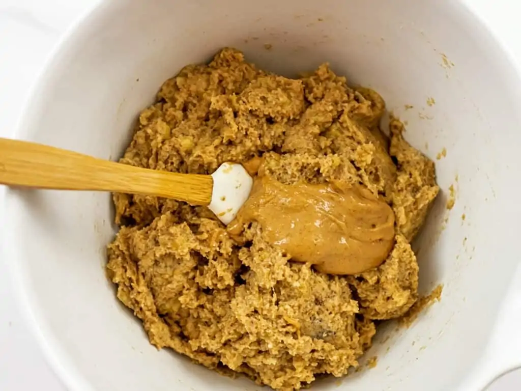 Peanut butter being added to the almond flour banana batter.