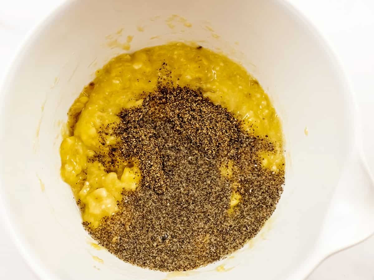 Mashed bananas, ground chia seeds and water in a bowl.
