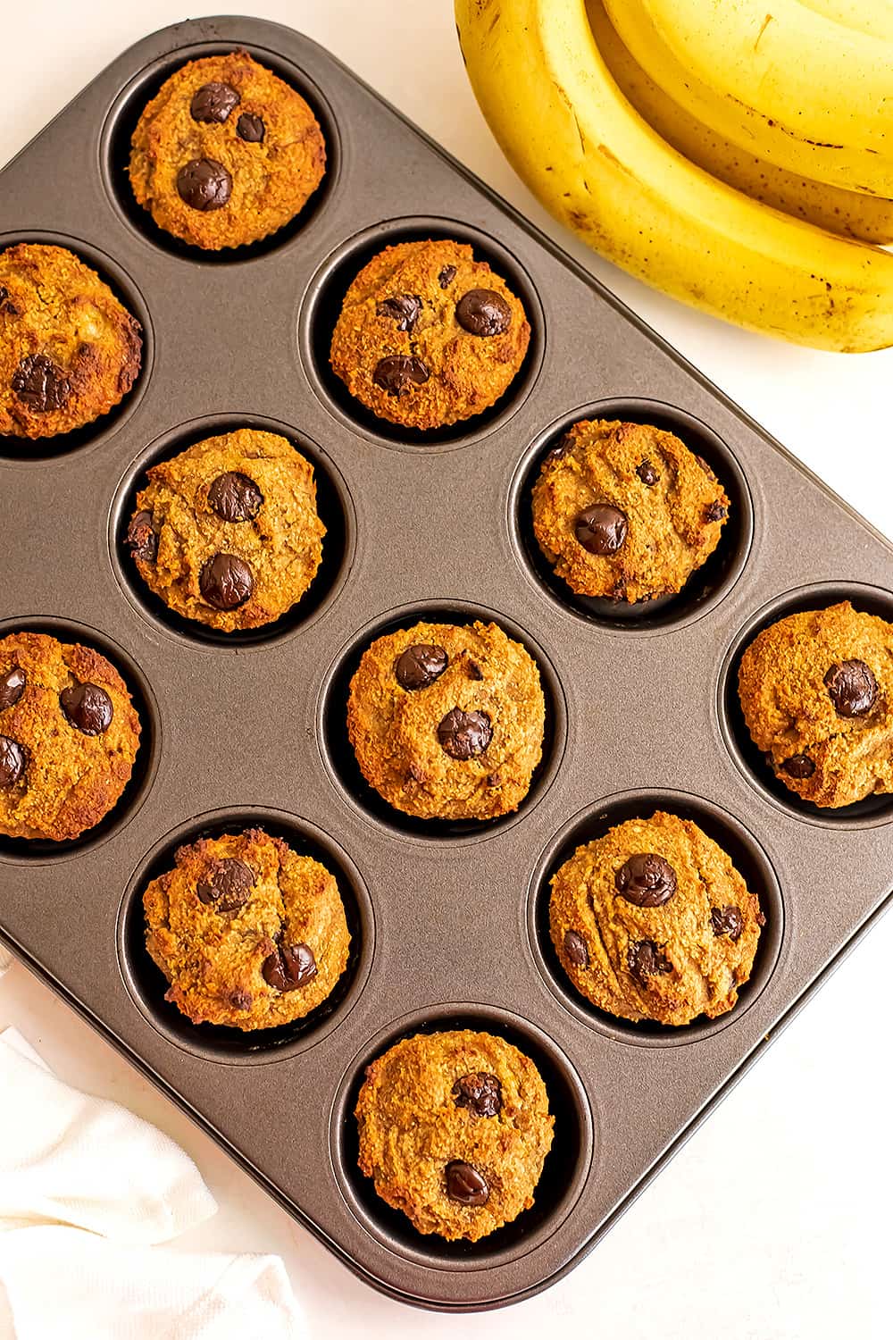 Banana almond flour muffins in a muffin tin.