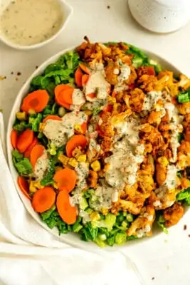 Large bowl filled with buffalo cauliflower salad with tahini ranch.