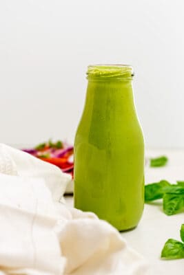 Creamy basil dressing in a bottle.