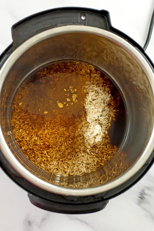 Fried rice ingredients in the instant pot before adding chicken.