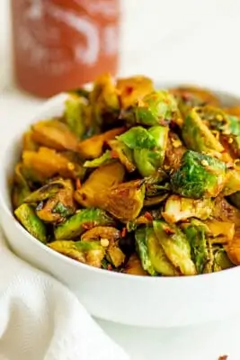 Bowl filled with sriracha brussel sprouts.