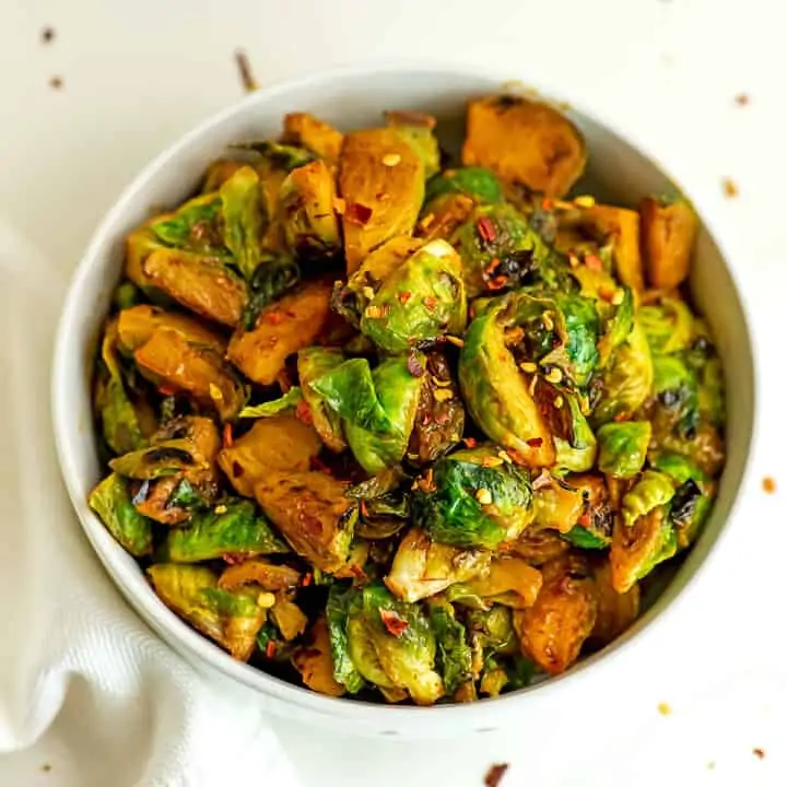 Sriracha brussel sprouts in a white bowl.
