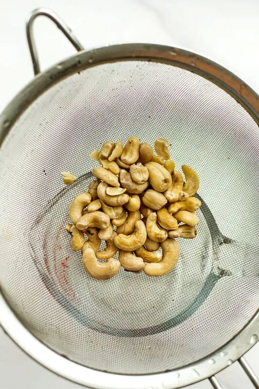 Cashews in a mesh strainer.
