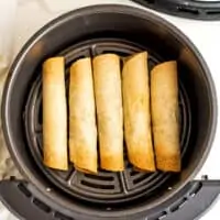 Vegan taquitos in air fryer after cooking.