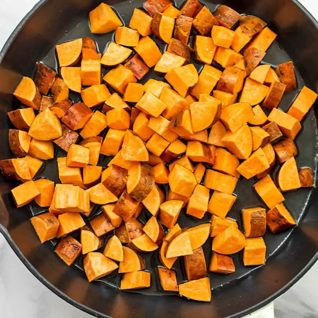 Sweet potatoes in skillet raw before cooking.