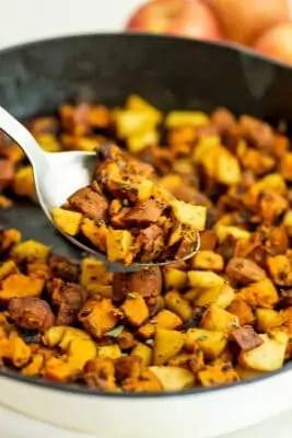 Serving spoon filled with whole30 sweet potato hash.