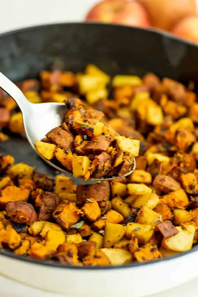 Serving spoon filled with whole30 sweet potato hash.