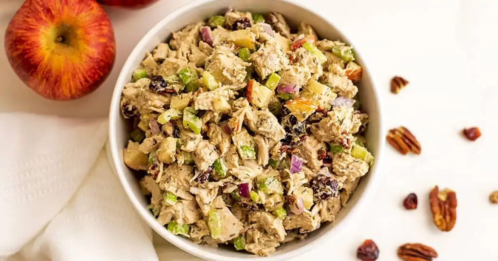 Large bowl filled with cranberry pecan chicken salad.