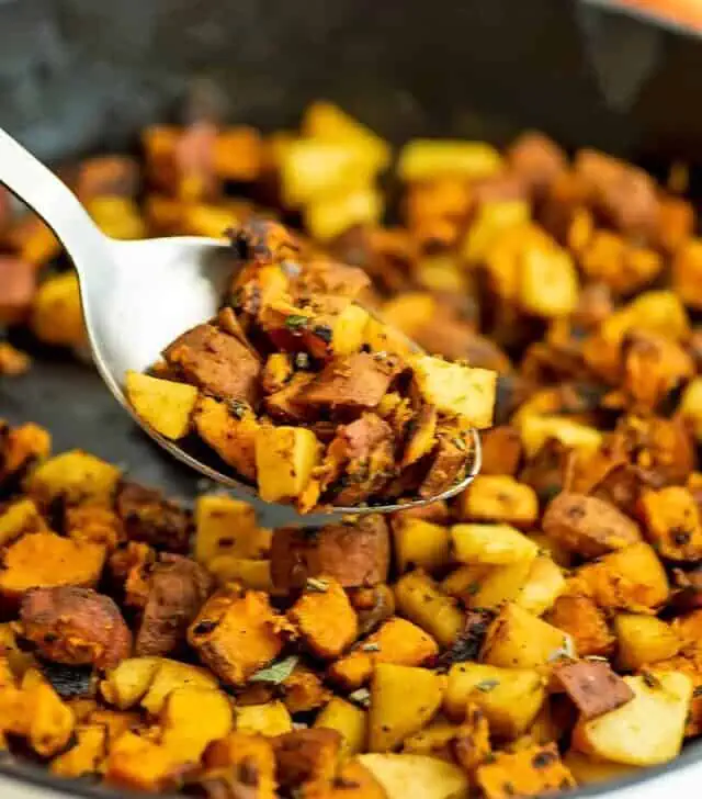 Serving spoon filled with whole30 sweet potato hash.